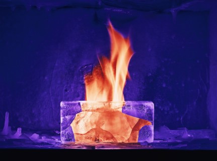 Orange flame burning in purple ice