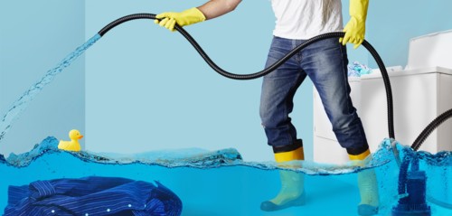 Man pumping water in flooding laundry room