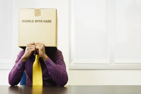 Black businessman with box over his head