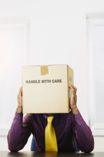 Black businessman with box over his head