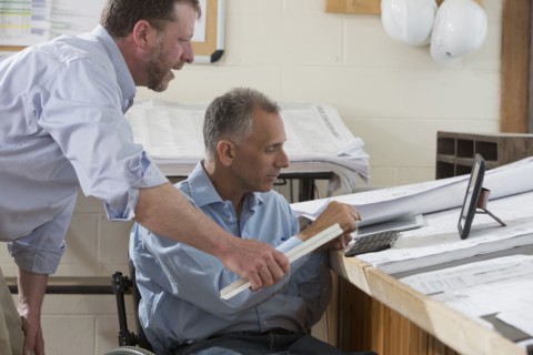 Caucasian architects talking in office