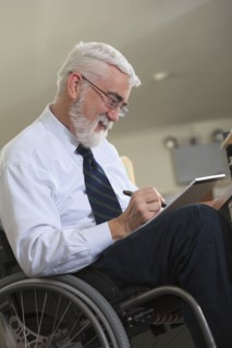 Caucasian businessman writing on notepad in office