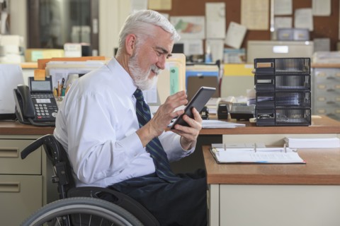 Caucasian businessman using digital tablet in office