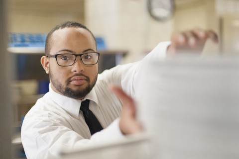 Mixed race server with down syndrome working in restaurant