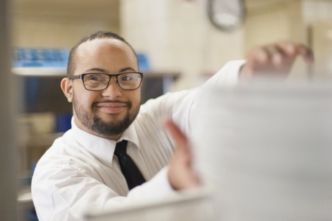 Mixed race server with down syndrome working in restaurant