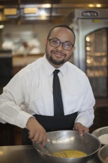 Mixed race chef with down syndrome cooking in restaurant