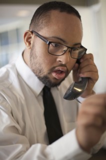 Mixed race man talking on telephone