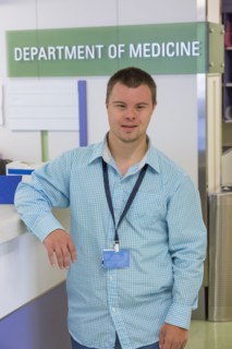 Caucasian man with Down Syndrome working in hospital