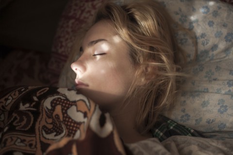 Caucasian woman sleeping in bed