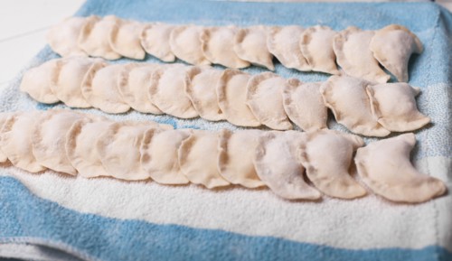 Rows of pierogies on towel