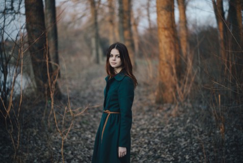 Caucasian woman standing near trees and river