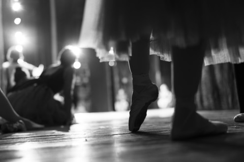Legs of woman wearing ballet shoes