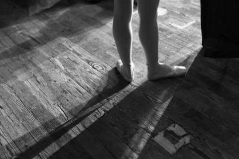 Legs of woman wearing ballet shoes