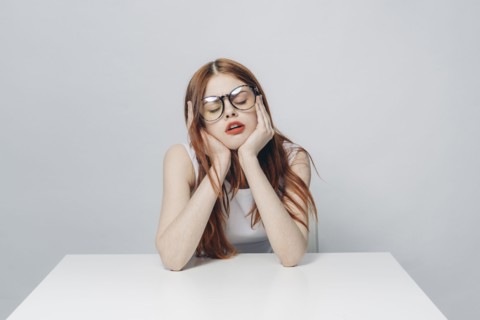 Frustrated Caucasian woman sitting at table
