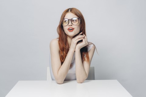 Happy Caucasian woman sitting at table