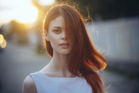 Portrait of Caucasian woman with hair covering face