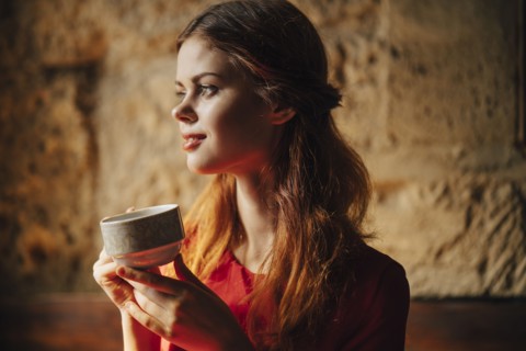 Caucasian woman holding cup of tea