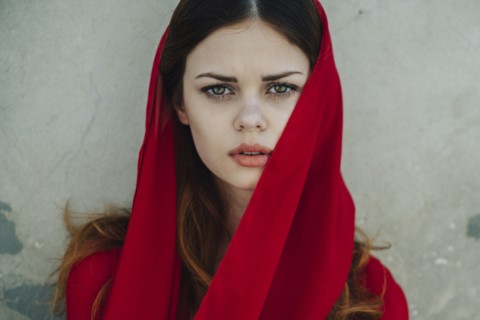 Serious Caucasian woman wearing red headscarf