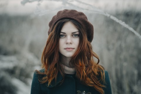 Serious Caucasian woman standing in field