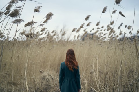 Rear view of Caucasian woman standing in field