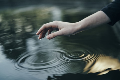 Water dripping from hand of woman