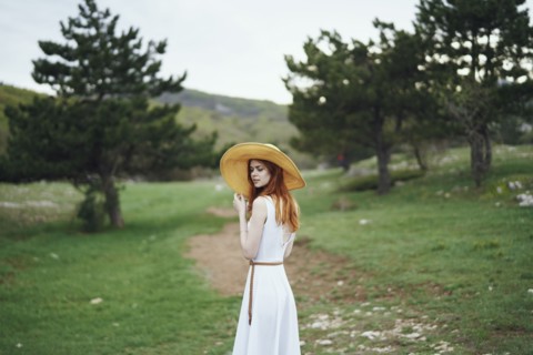 Woman wearing sun hat standing in field