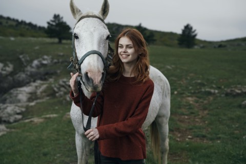 Caucasian woman petting horse