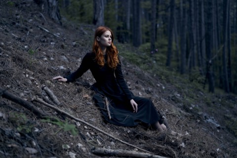 Caucasian woman sitting on hill