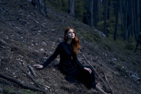 Caucasian woman sitting on hill