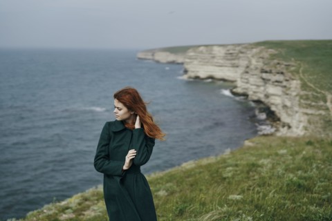 Caucasian woman standing near ocean