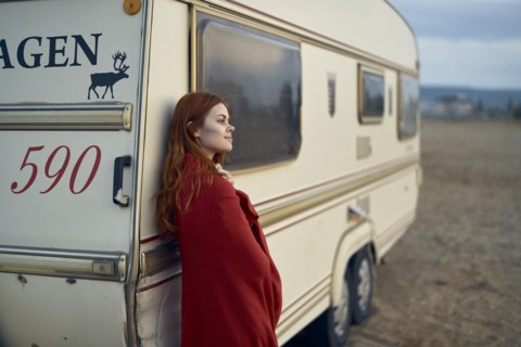 Caucasian woman leaning on motor home