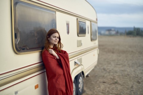 Caucasian woman leaning on motor home