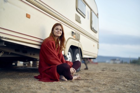 Caucasian woman leaning on motor home