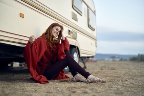 Caucasian woman leaning on motor home