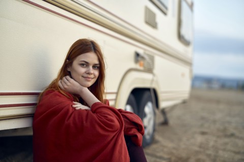 Caucasian woman leaning on motor home