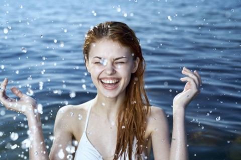 Caucasian woman splashing in ocean