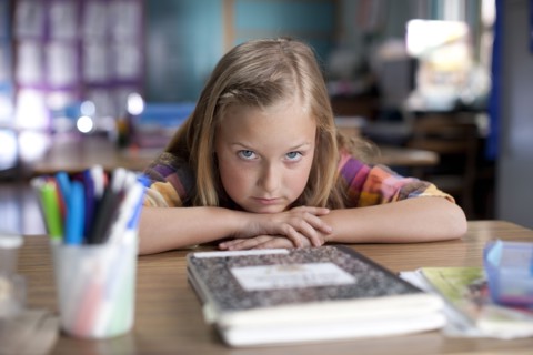 Bored Caucasian girl sitting in classroom