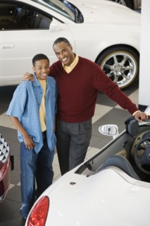 Father and son at a car dealership