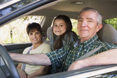 Hispanic family sitting in car