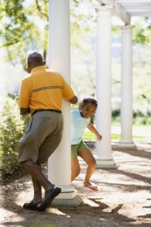 African American grandfather and granddaughter playing outdoors