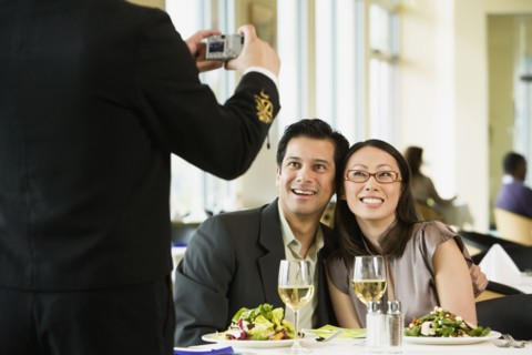 Couple having photograph taken at restaurant
