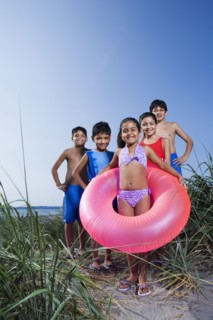 Hispanic children in bathing suits on beach