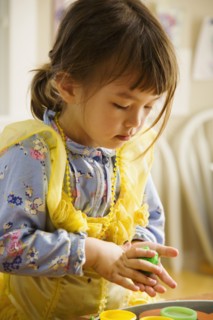 Asian girl playing with clay