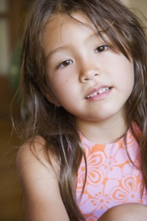 Close up of young Asian girl indoors