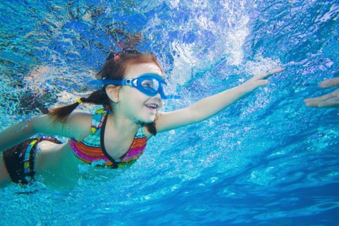 Underwater shot of Asian girl swimming