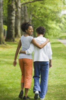 African American mother and adult daughter hugging