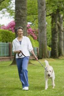 African American woman walking dog