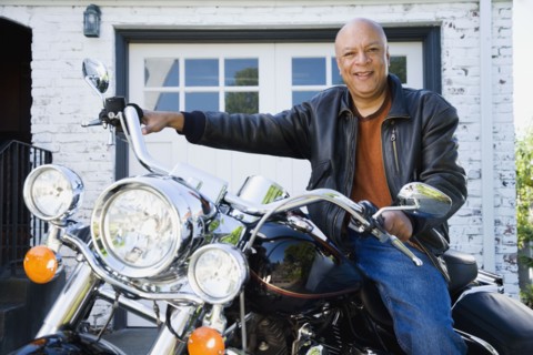 Senior African American man sitting on motorcycle
