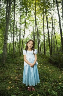 Asian girl wearing costume in woods