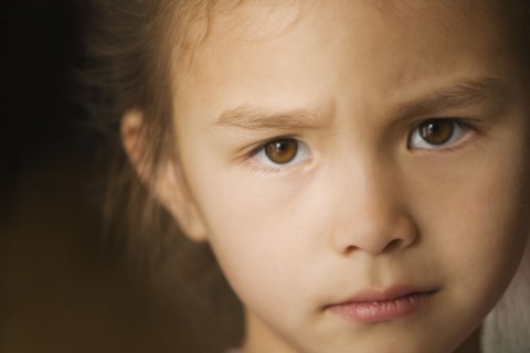 Close up of Asian girl with furrowed brow